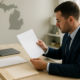 Michigan personal injury medical liens settlement documents reviewed at a professional desk